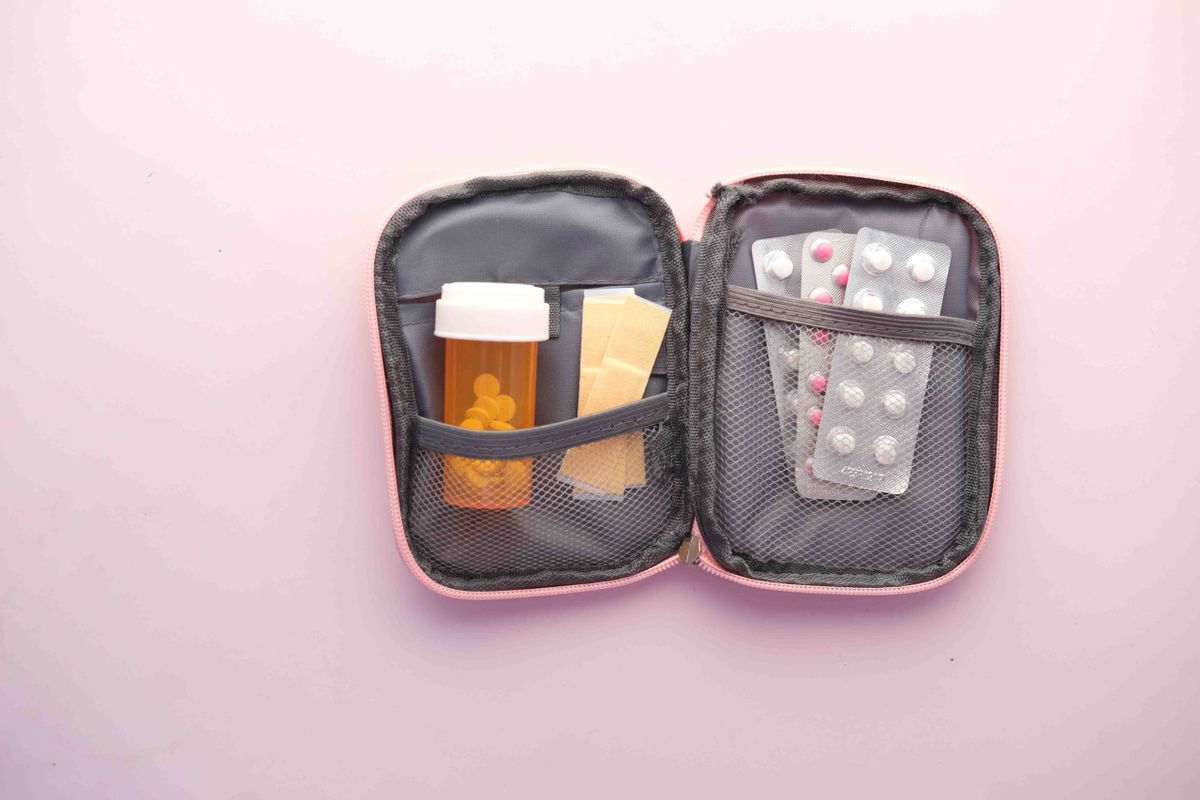 Travel medicine pouch with pills and bandages